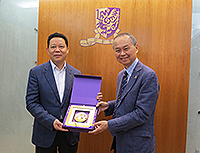 Professor Fok Tai-fai (right), Pro-Vice-Chancellor of CUHK presents a souvenir to Mr. Yang Xingping, Vice Governor of Sichuan Province
